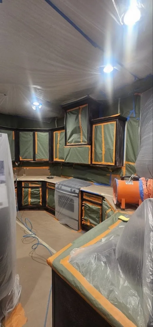 Kitchen cabinetry and protected work surfaces before refinishing