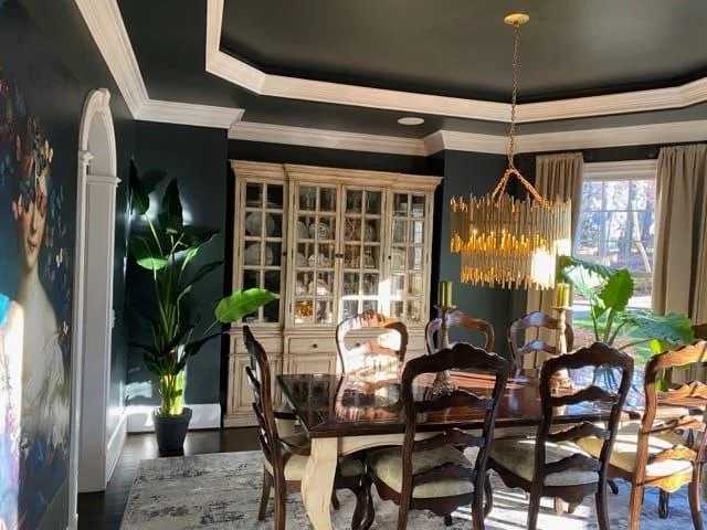 Dining room with decorative ceiling and painted walls
