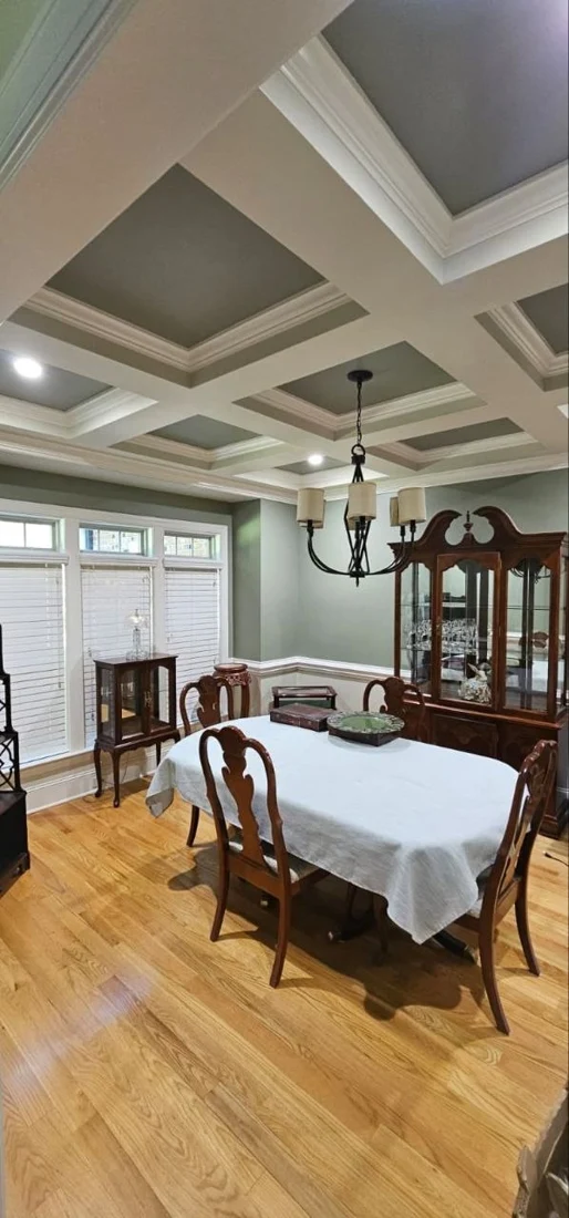 Finished dining room with coffered ceiling and painted trim