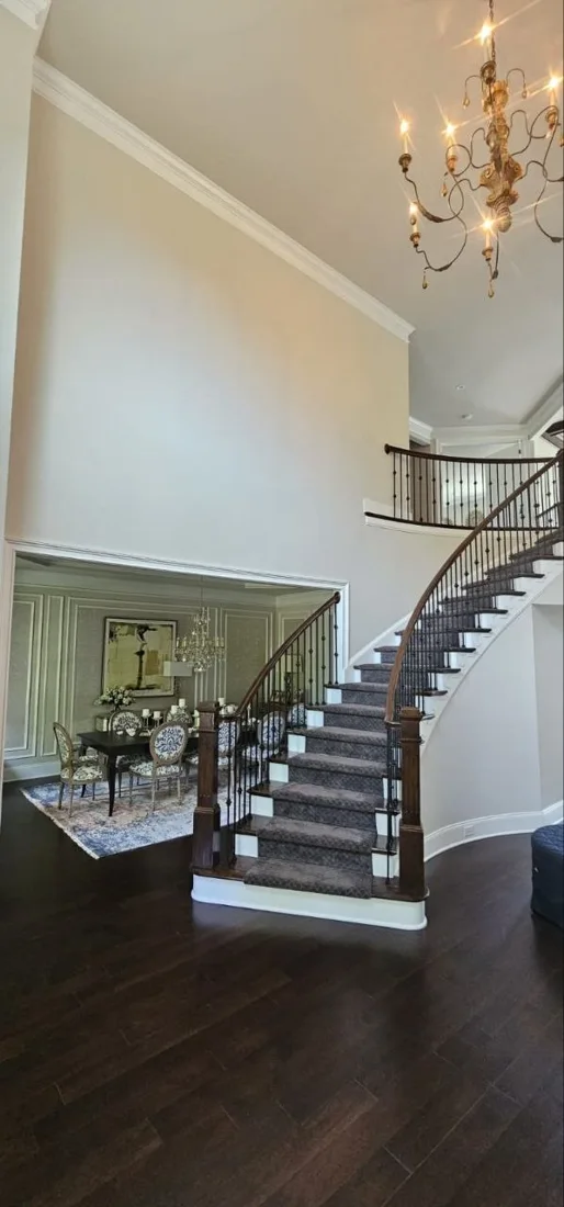 Tall entryway with finished walls and staircase