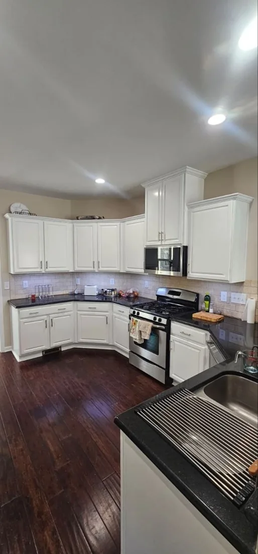 Finished kitchen with recessed lighting and dark flooring