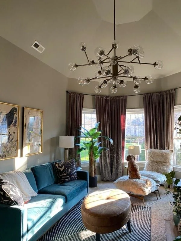 Finished living room with tall windows and painted walls