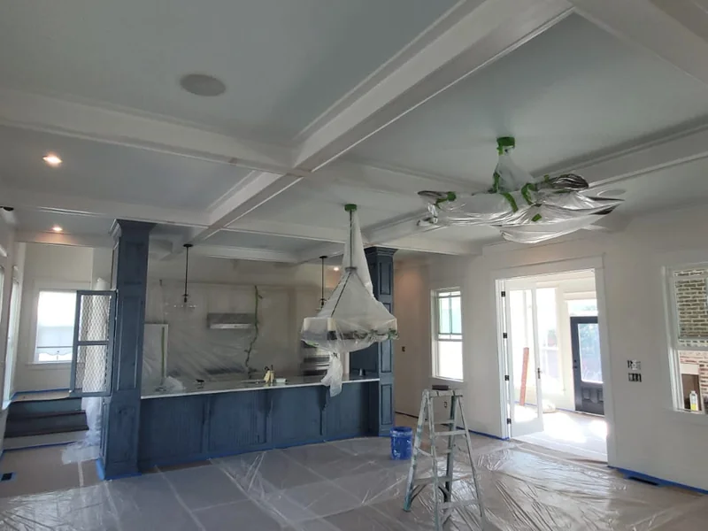 Bright interior room with covered floors and prepared surfaces